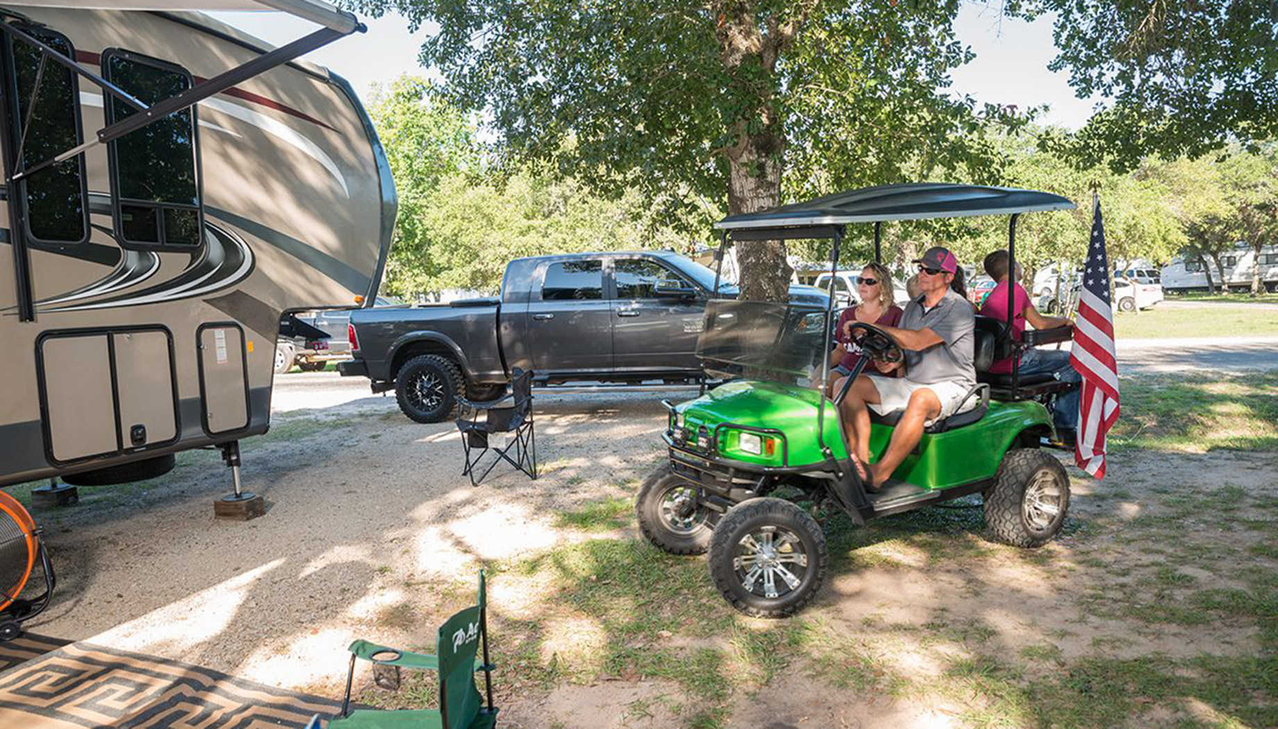 BLOG Family driving to their RV in a bright green golf cart.