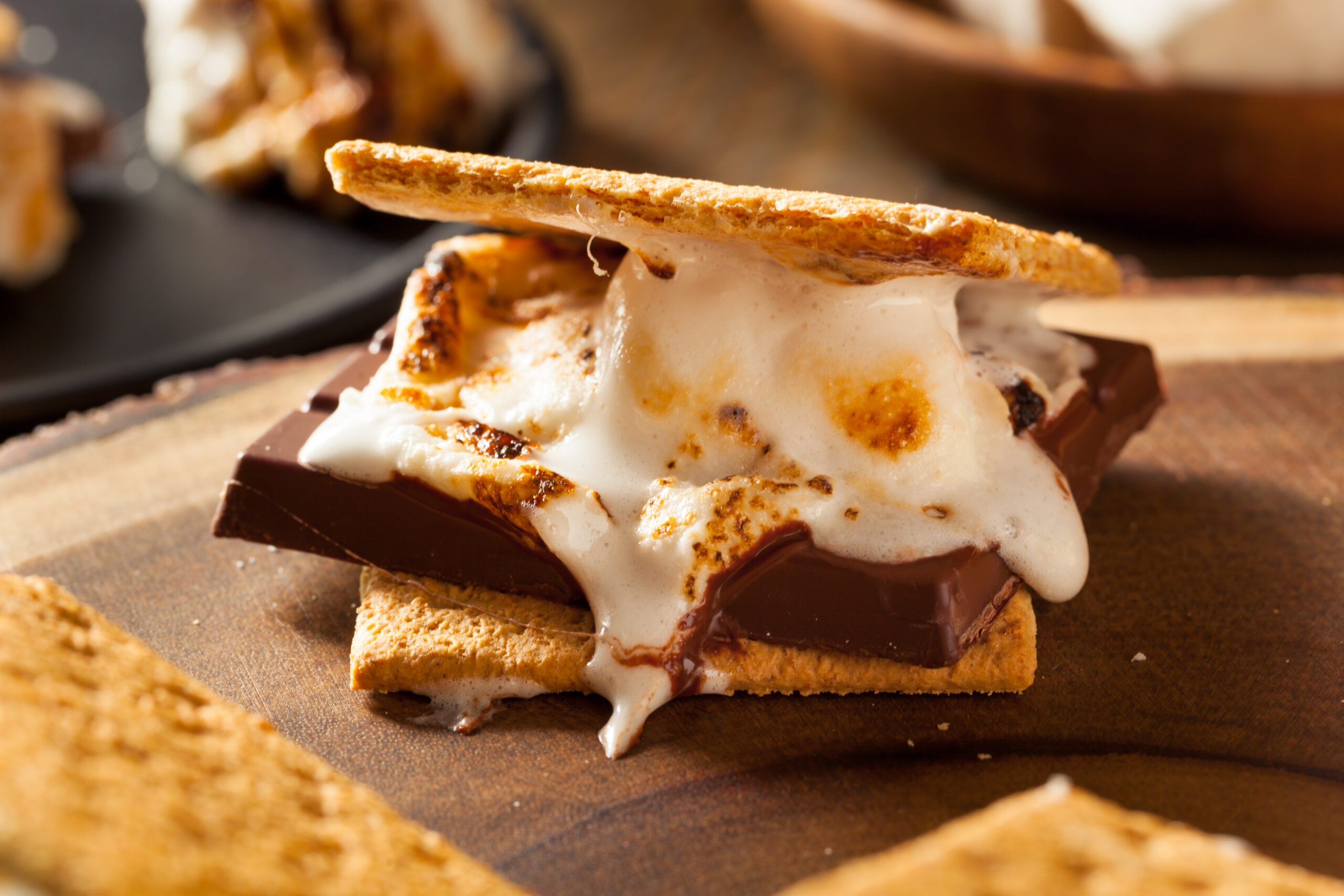 Homemade Gooey Marshmallow S’mores Gooey marshmallow smores on a wooden dish.